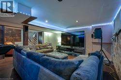 Living area with wood finished floors and recessed lighting -