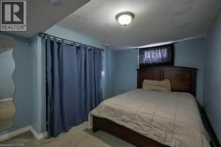 Carpeted bedroom featuring baseboards -