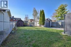 Fenced backyard with a storage unit -