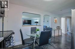 Dining room with baseboards and arched walkways -