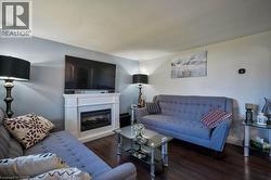 Living room featuring a premium fireplace and wood finished floors -