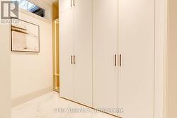Mudroom w/custom cabinetry. Shoes rack/led light -