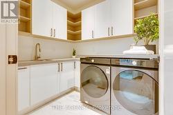 Upper level laundry w/custom cabinetry -