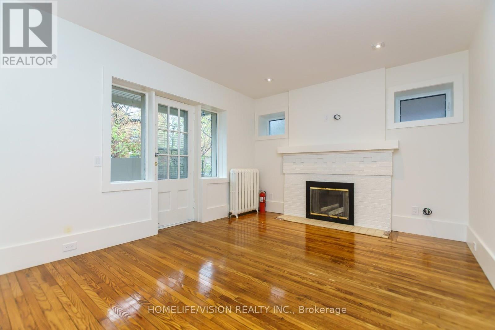 1 - 302 Sumach Street, Toronto, ON - Indoor Photo Showing Living Room With Fireplace