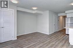Empty room featuring a textured ceiling and light wood finished floors -