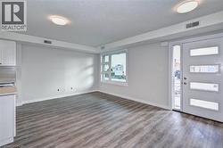 Foyer entrance featuring a textured ceiling and dark wood-style floors -