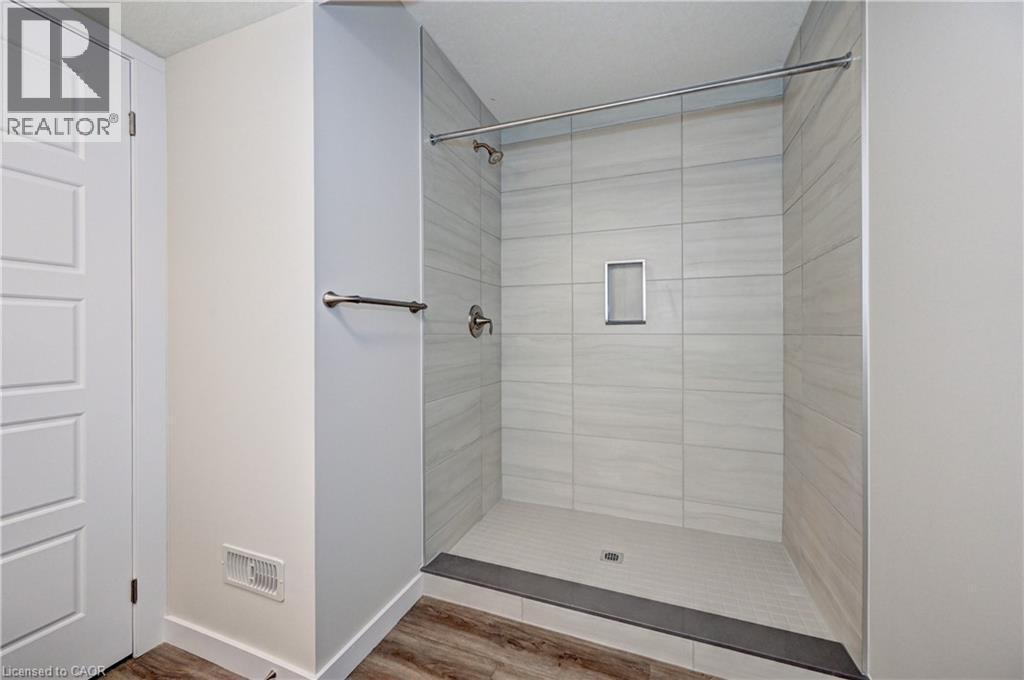 Full bathroom with a stall shower and wood finished floors - 118 Gravel Ridge Trail Unit# G21, Kitchener, ON - Indoor Photo Showing Bathroom