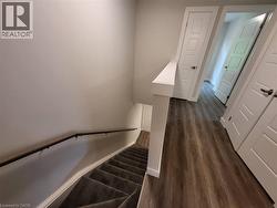 Stairway featuring baseboards and wood finished floors -