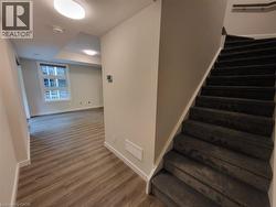 Stairway featuring baseboards and wood finished floors -