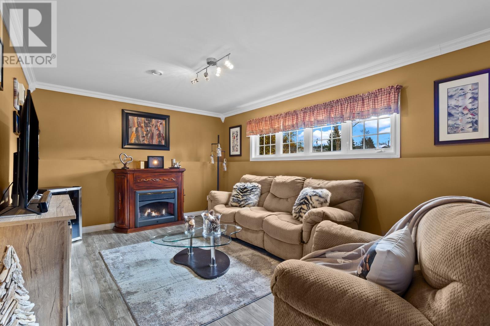 18 Shaheen Crescent, Come By Chance, NL - Indoor Photo Showing Living Room With Fireplace