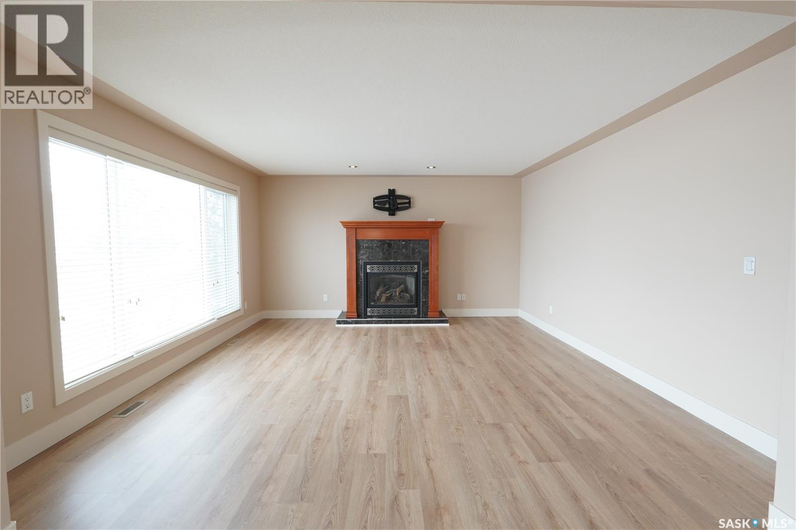 15 Christopher Place, White City, SK - Indoor Photo Showing Living Room With Fireplace