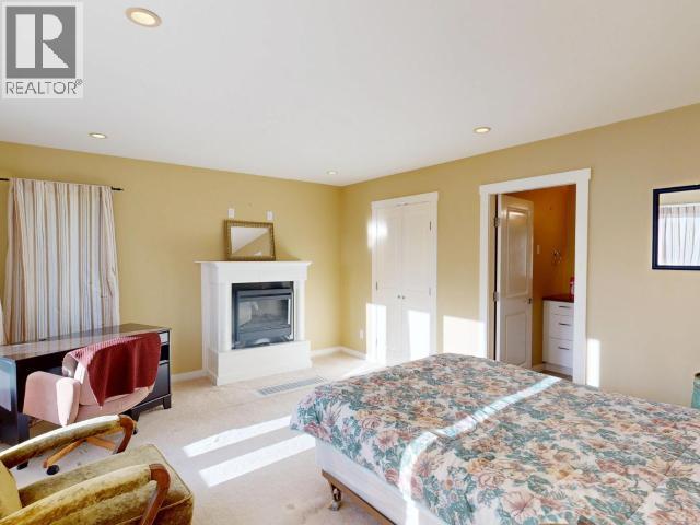 3004 Pebble Beach Road, Powell River, BC - Indoor Photo Showing Bedroom With Fireplace