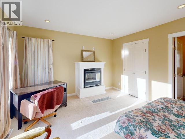 3004 Pebble Beach Road, Powell River, BC - Indoor Photo Showing Bedroom With Fireplace