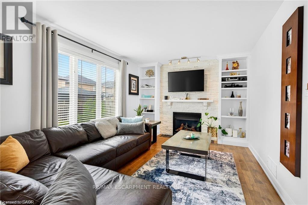 Living room w/gas fireplace and stone feature wall - 39 Wilbur Drive, Hamilton, ON - Indoor Photo Showing Living Room With Fireplace