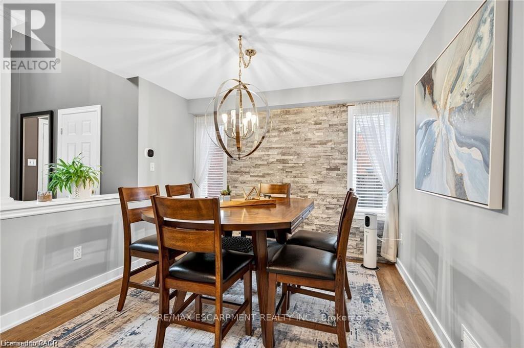 Separate dining room with stone feature wall - 39 Wilbur Drive, Hamilton, ON - Indoor Photo Showing Dining Room