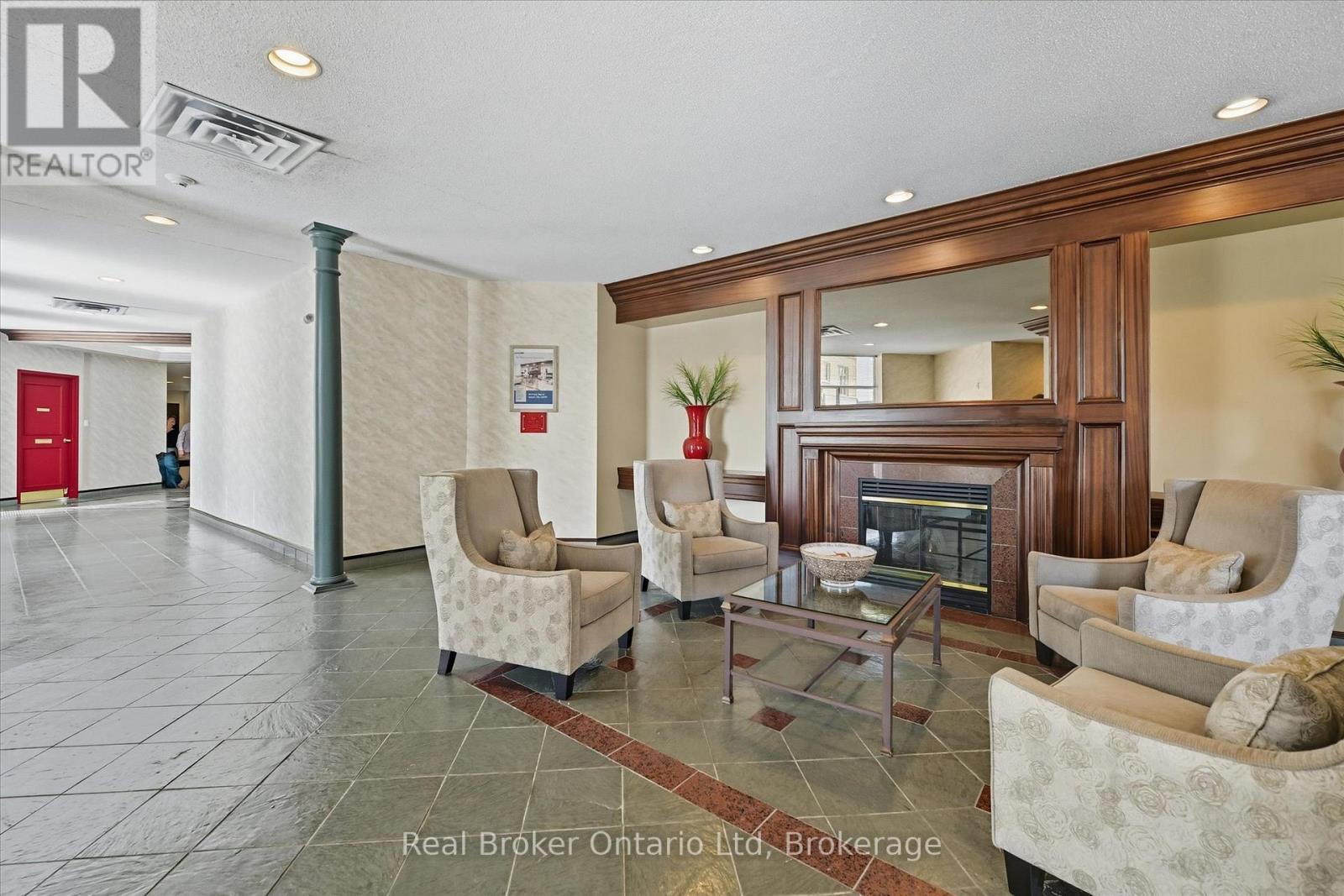 524 - 8111 Forest Glen Drive, Niagara Falls (Mt. Carmel), ON - Indoor Photo Showing Living Room With Fireplace