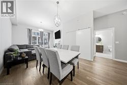 Dining space featuring light wood-type flooring and a chandelier -