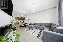 Living room featuring light wood-type flooring and a chandelier -