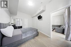 Bedroom with wood finished floors and baseboards -