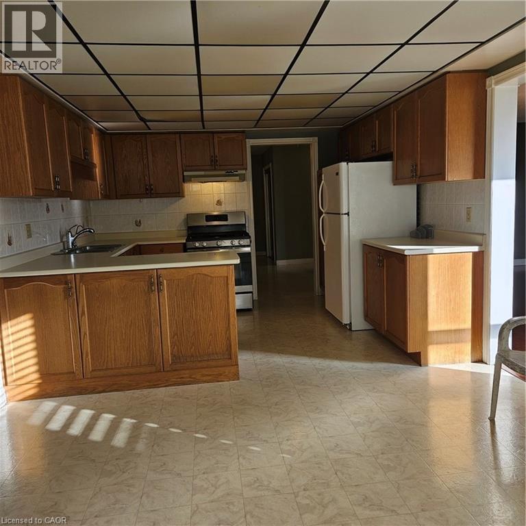 Kitchen with extractor fan, stainless steel range, kitchen peninsula, and sink - 115 Cranston Avenue, Cambridge, ON - Indoor Photo Showing Kitchen