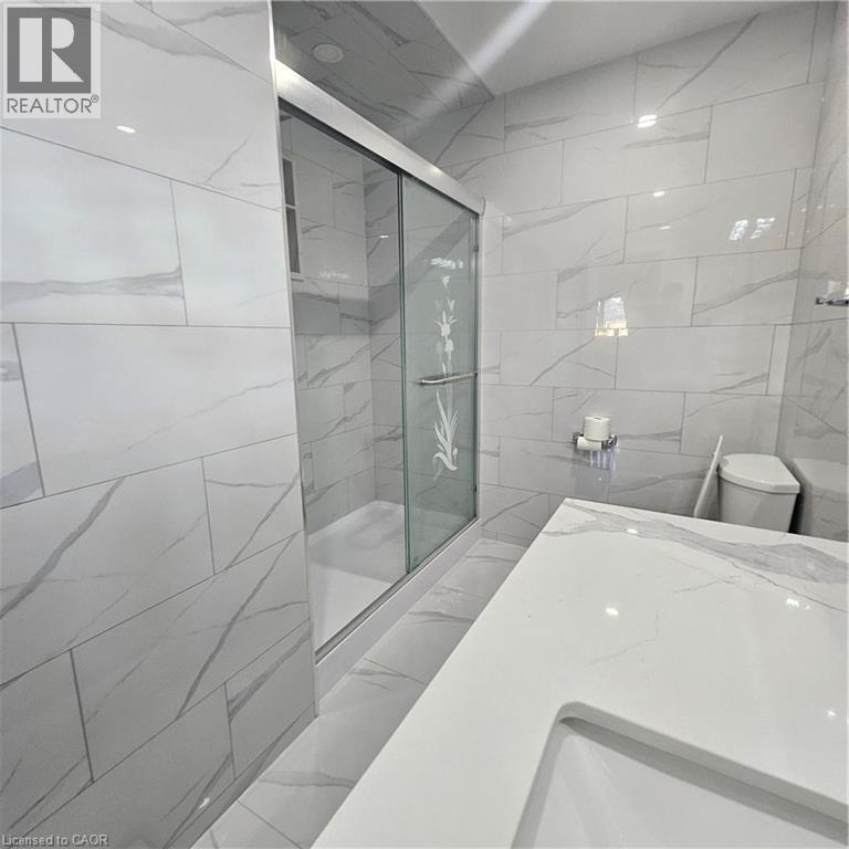 Bathroom with walk in shower, toilet, and tile walls - 115 Cranston Avenue, Cambridge, ON - Indoor Photo Showing Bathroom