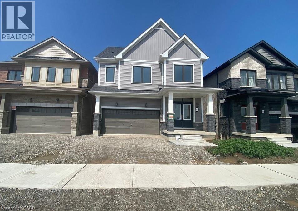 Craftsman inspired home featuring covered porch, a garage, driveway, and board and batten siding - 88 Bellhouse Avenue Unit# Bsmt, Brantford, ON - Outdoor With Facade