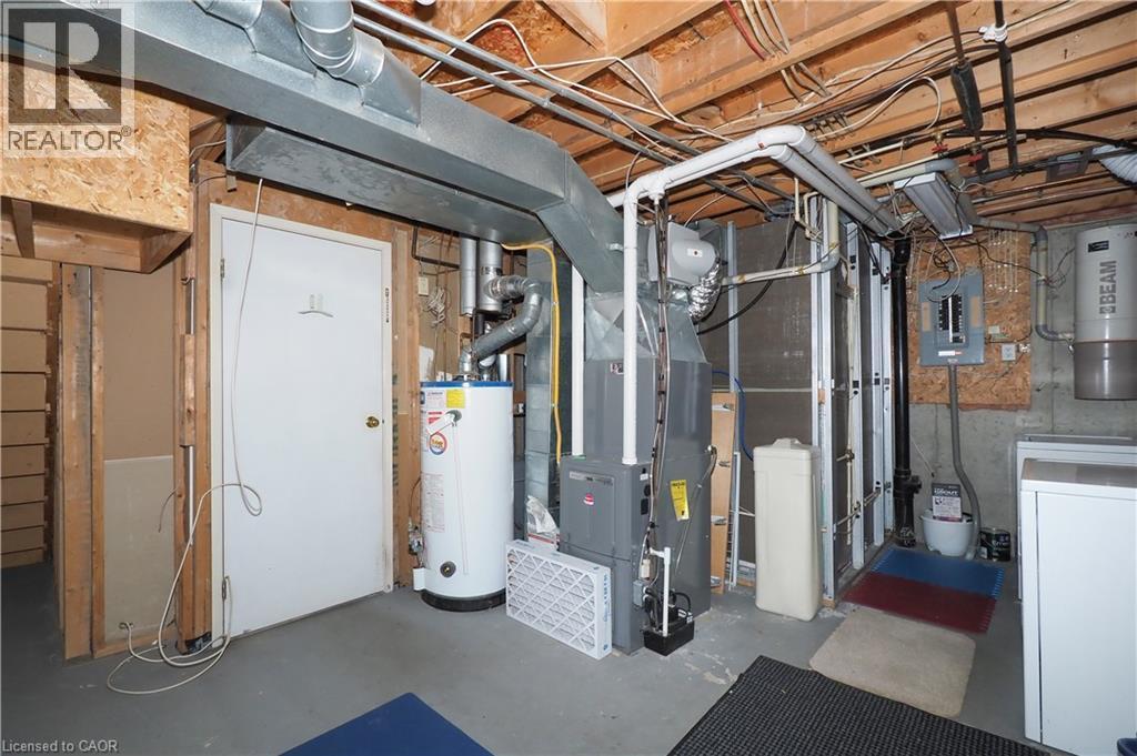 Unfinished below grade area with water heater, electric panel, washer / dryer, and heating unit - 255 Northlake Drive Unit# 27, Waterloo, ON - Indoor Photo Showing Basement