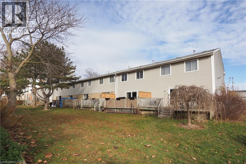 Rear view of house with a yard and a deck - 255 Northlake Drive Unit# 27, Waterloo, ON - Outdoor With Deck Patio Veranda