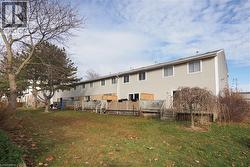 Rear view of house with a yard and a deck -