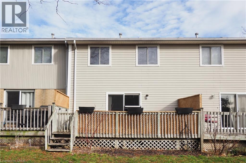 Back of house with a wooden deck - 255 Northlake Drive Unit# 27, Waterloo, ON - Outdoor With Deck Patio Veranda With Exterior
