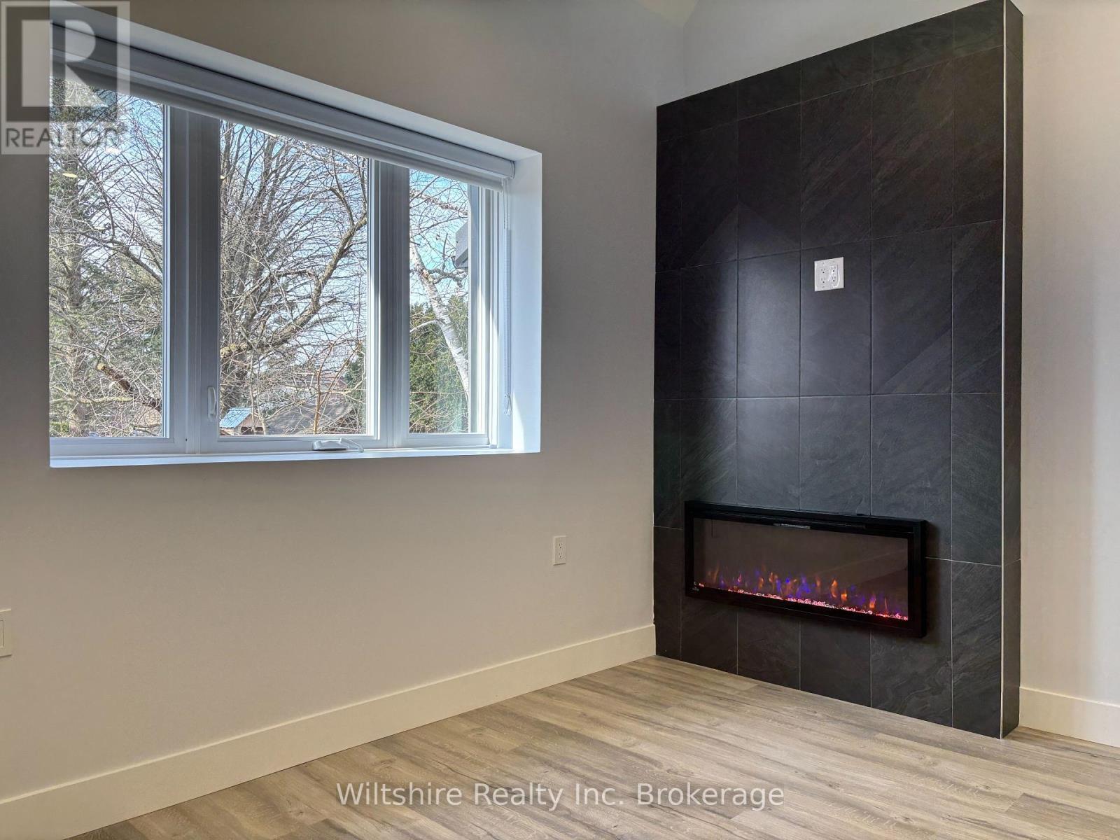 4 - 14 Glendale Drive, Tillsonburg, ON - Indoor Photo Showing Other Room With Fireplace