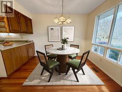Dining area with hardwood. Virtually staged. -