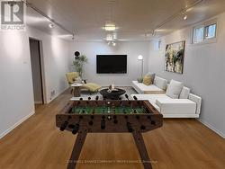 Bright and spacious rec room. Virtually staged. -