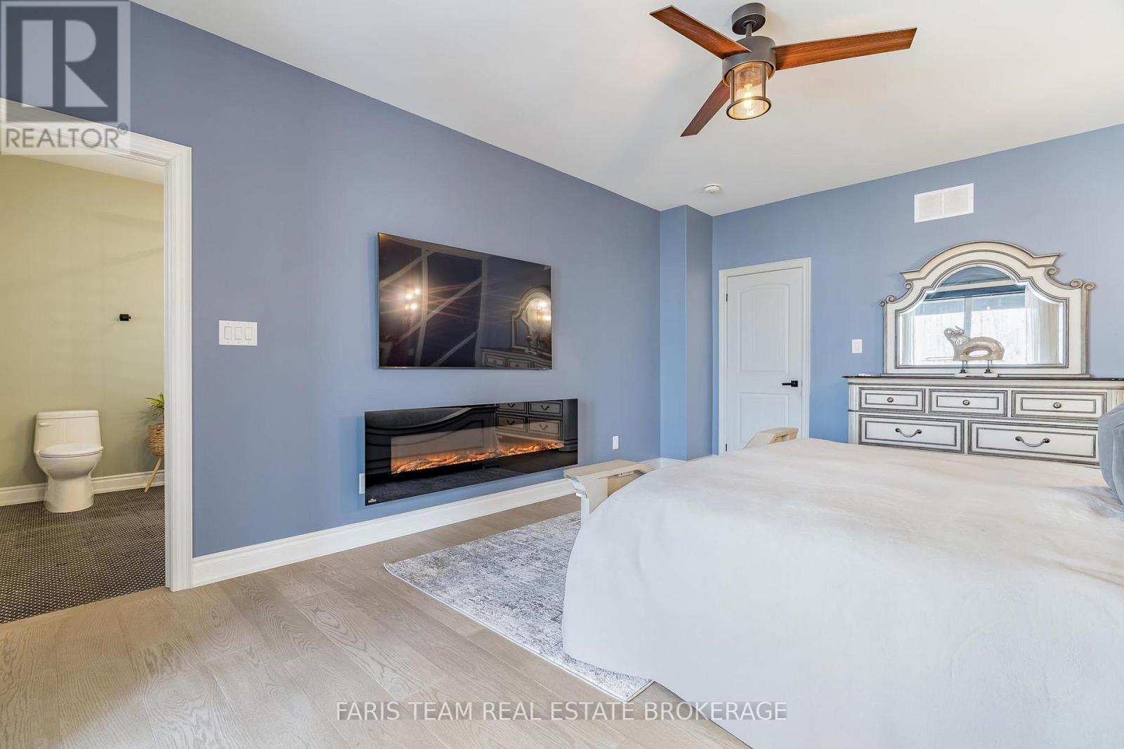 9 Byers Street, Springwater, ON - Indoor Photo Showing Bedroom With Fireplace