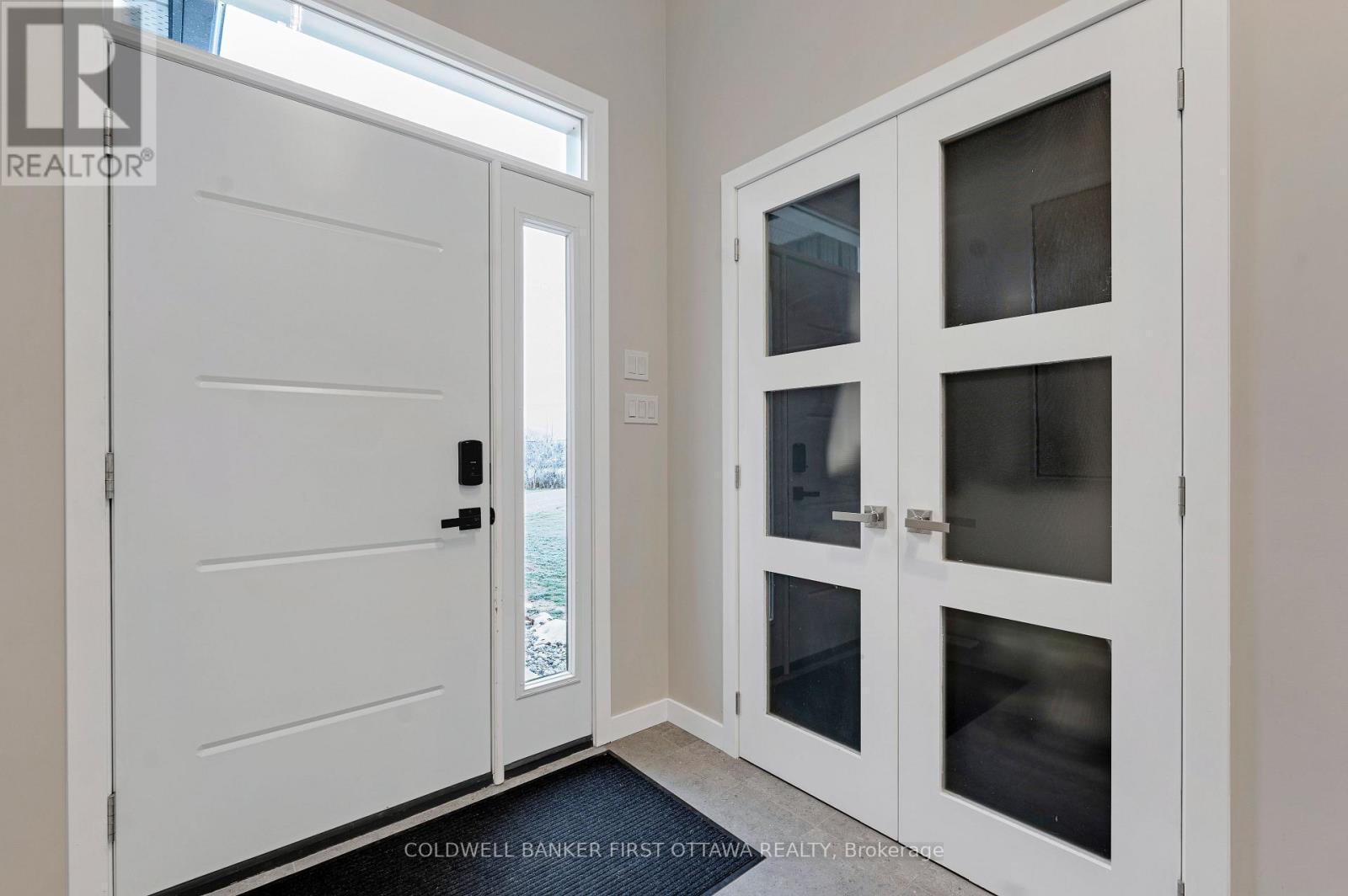 Bright foyer with double closet & porcelain floor - 462 Althorpe Road, Tay Valley, ON - Indoor Photo Showing Other Room
