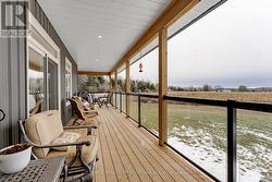 Wrap-about deck with metal frame & glass railing -