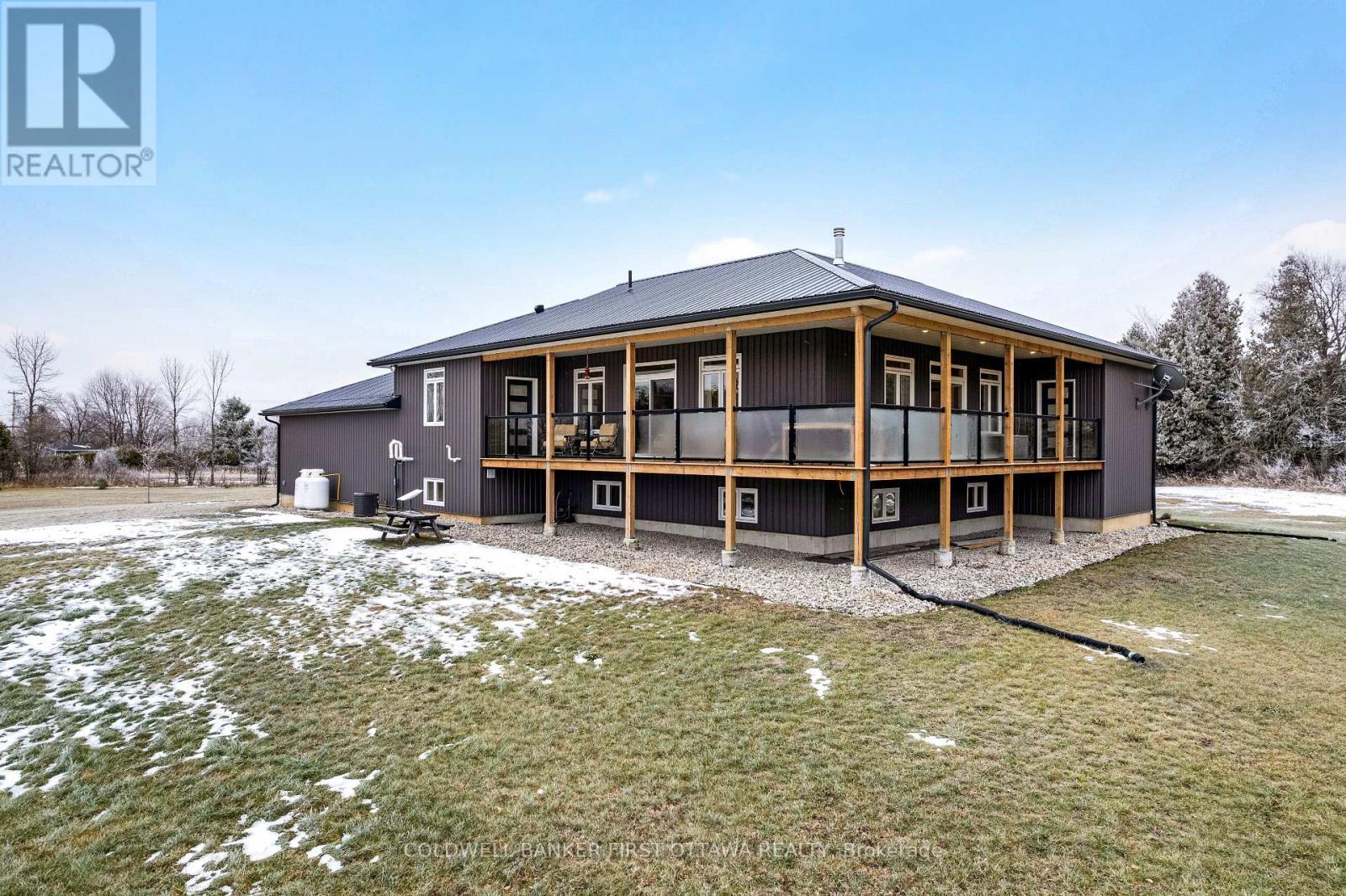 Steel fascia has recessed soffit lighting - 462 Althorpe Road, Tay Valley, ON - Outdoor With Deck Patio Veranda