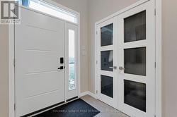 Bright foyer with double closet & porcelain floor -