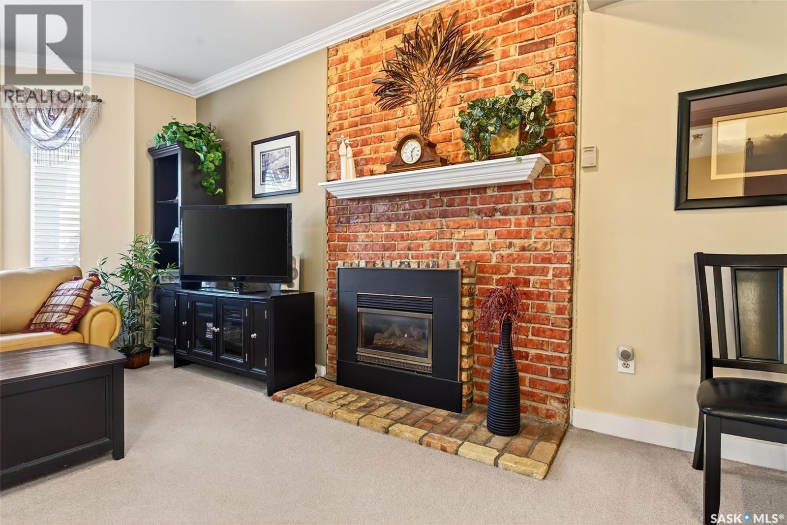 304 2925 14Th Avenue, Regina, SK - Indoor Photo Showing Living Room With Fireplace
