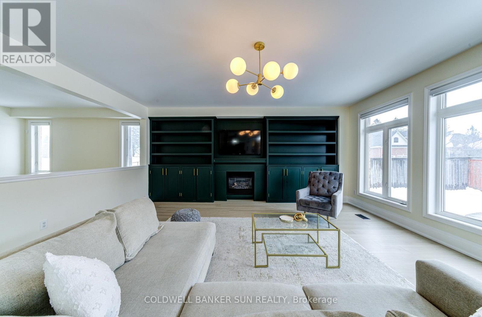 33 Ellis Crescent, Kawartha Lakes, ON - Indoor Photo Showing Living Room With Fireplace