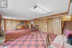 Expansive Recreation Room with Wood Paneling -