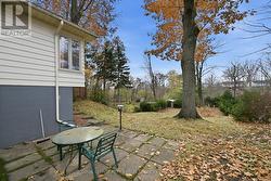 The Fully Fenced Backyard Features Towering Trees -