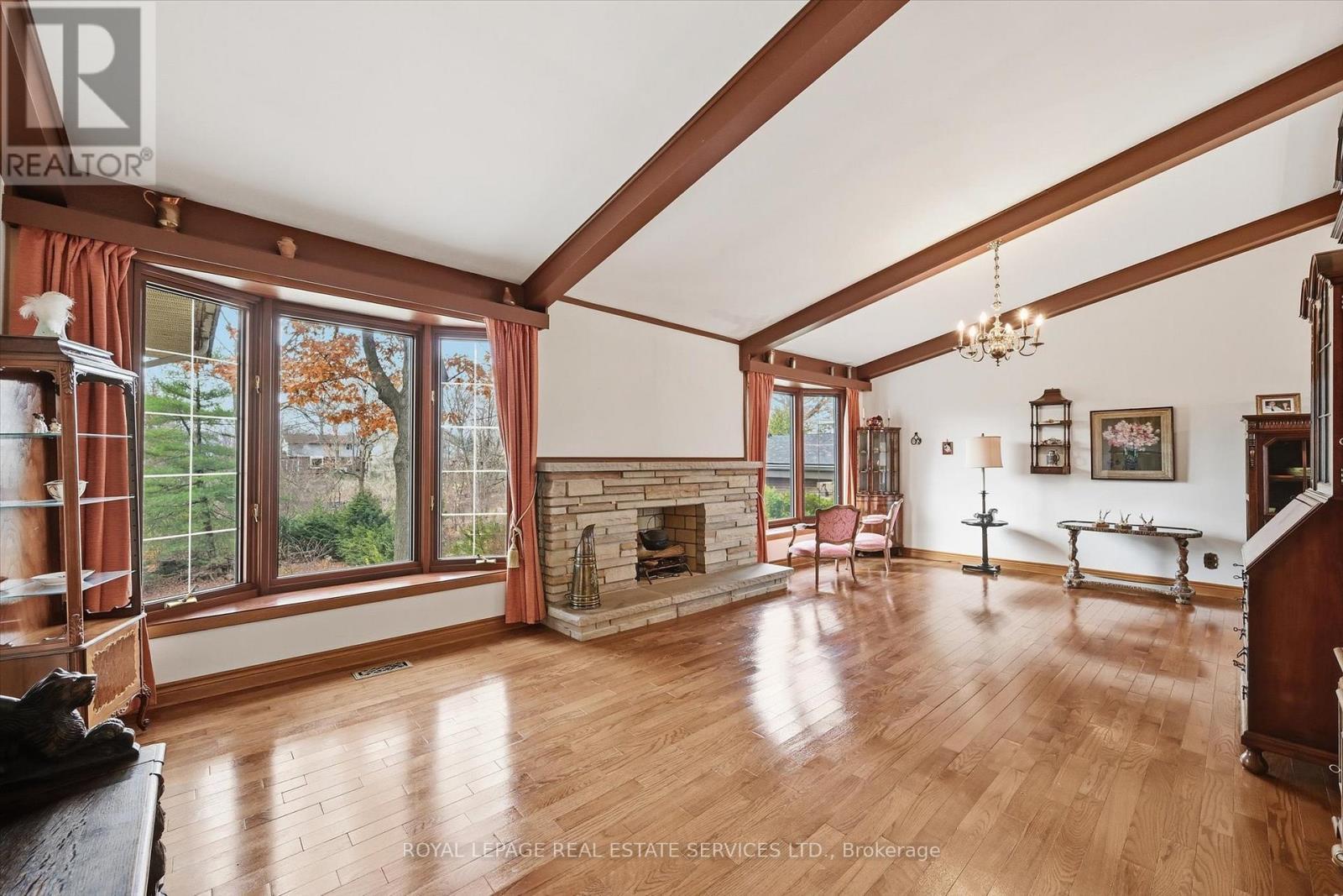 Oversized Living Room with a Woodburning Fireplace - 5089 Meadowhill Road, Burlington, ON - Indoor With Fireplace