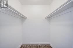 Primary bedroom walk in closet -