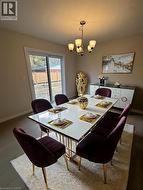 Dining space with baseboards and a chandelier -