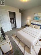 Carpeted bedroom featuring a closet and baseboards -