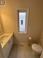 Half bathroom with vanity and light marble finish flooring -