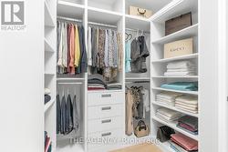 LED lit Primary Walk-in closet w/skylight -