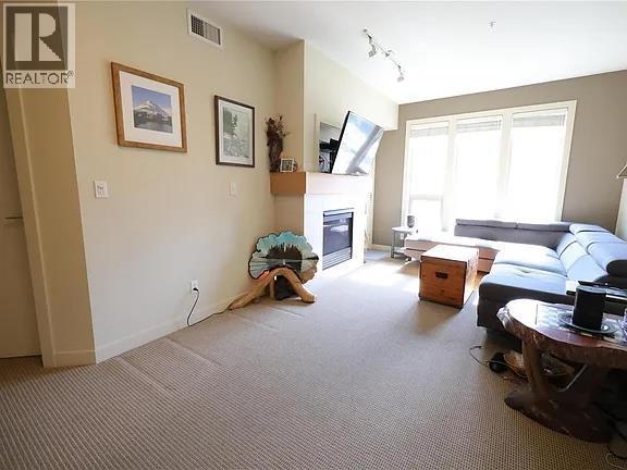 7343 Okanagan Landing Road Unit# 2204, Vernon, BC - Indoor Photo Showing Other Room With Fireplace