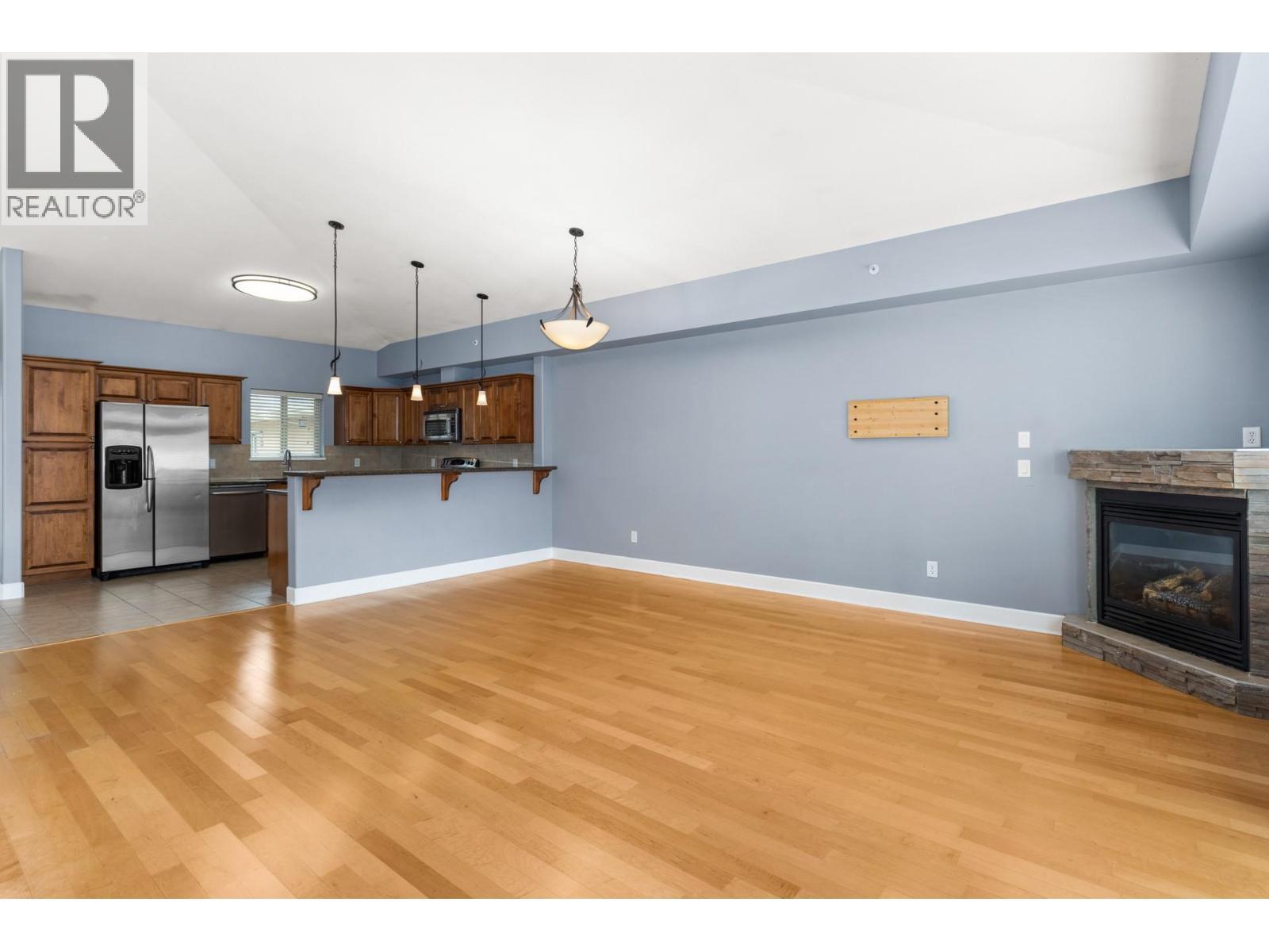 Gas fireplace - 3996 Beach Avenue Unit# 335, Peachland, BC - Indoor Photo Showing Other Room With Fireplace